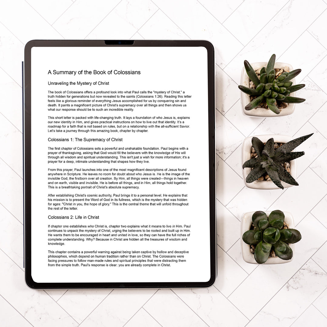 Tablet displaying a text document on a white surface with succulent plants.